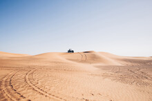 Beautiful Desert Landscape With Wheel Traces And Black Buggy Quad Bike Up On Hill, Al Awir Sand Dunes, Dubai, UAE  