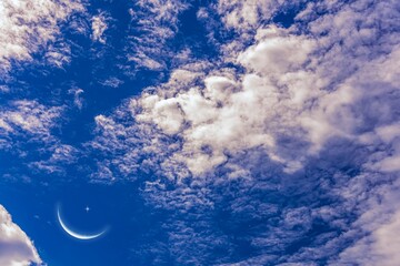 Wall Mural - young month in clouds sky, background of religion