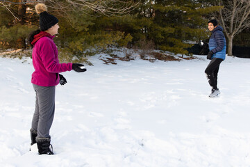 Siblings Having a Snowball Fight in Winter