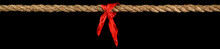 Long Tug Of War Rope Pulled Tight, With Red Ribbon Tie. Concept Of Conflict, Competition, Or Rivalry.  Isolated On Black.