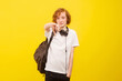 © Дина Морозова - Empty space for the text. Yellow background. Teen shows thumb down.