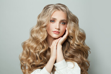 Wall Mural - nice woman fashion model with clear skin and healthy wavy hair on white background