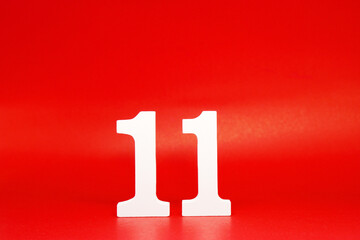 Eleven ( 11 ) white number wooden on Red Background with Copy Space - New promotion 11% Percentage  Business finance Concept 