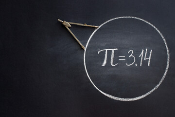 The Greek letter Pi, the ratio of the circumference of a circle to its diameter, is drawn in chalk on a black chalkboard with a compass in honor of the international number Pi for March 14