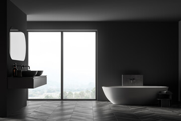 Bathtub and sinks with mirror in dark bathroom with window