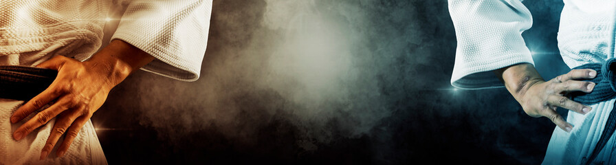 Martial arts masters on dark smoke background