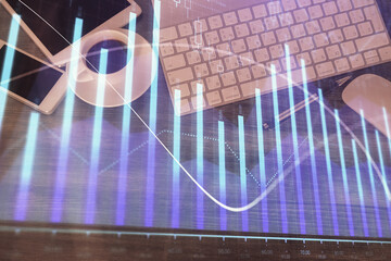 Double exposure of forex chart hologram over desktop with phone. Top view. Mobile trade platform concept.