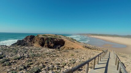 Wall Mural - Point of view of walking on a boardwalk on the beach in Costa Vicentina, Sagres, Portugal.