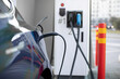 © sofiko14 - Electric car at charging station with the power cable supply plugged in