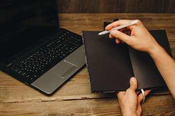 Fototapete - workplace blogger. set to prepare for public speaking and writing text: keyboard and phone on a wooden table, top view. freelancer writes the text in a notebook