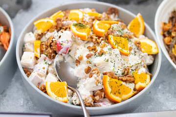 Wall Mural - Potato salad and fresh orange with walnut on salad bar. 