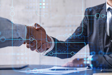 handshake of two businessmen who enters into the contract to develop a new software to improve busin
