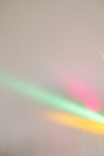 Neon Light Background. Rainbow Color. Disco Party. Festive Art Surface. Colorful Pink Yellow Green Blur Glowing Rays Overlay On Neutral Wall.