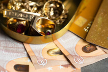 Old And Broken Jewelry  And On Euro Banknotes  And Credir Card On Dark Background. Sell Gold  For Money Concept.