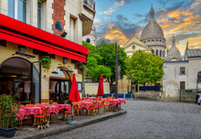Cozy Street With Tables Of Cafe In Quarter Montmartre In Paris, France. Architecture And Landmarks Of Paris. Postcard Of Paris