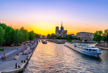 Wall Mural - sunset view of cathedral notre dame de paris, island cite and river seine in paris, france