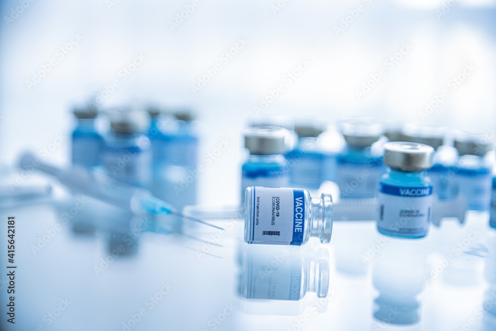 Ampoules with Covid-19 vaccine. Syringe with needle. Fighting the covid-19 virus. - obrazy, fototapety, plakaty 