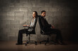 © Jurii - Bad relationship concept. Man and woman in disagreement. Young couple after a quarrel sitting on chairs back to back. Businessmen and partners did not share anything