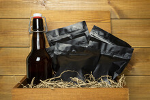 Bottle Of Craft Beer And Packages Of Assorted Snacks In A Wooden Gift Box On Natural Wood Background.