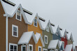 St. John's, Newfoundland, Canada - February 2021: Street View of multiple colourful row houses in downtown St. John's. The buildings have flat roofs, small windows, wood siding and multiple layers.