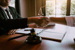 © wutzkoh - Lawyer is currently shaking hands with the client about the success in resolving the case.