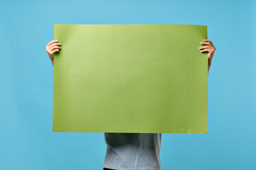 man holding green banner marketing copy space blue advertising background