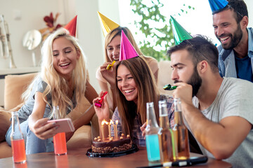 Wall Mural - Young woman celebrating birthday at home