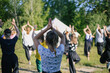 Girls pulls hands up. Group of children doing morning exercises yoga-sport outdoors in nature in a summer camp