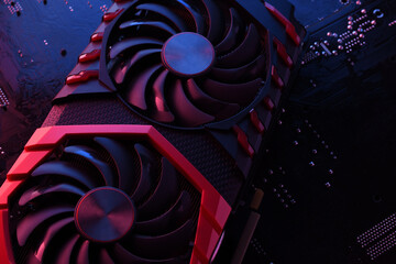 Poster - Computer game graphics card, videocard with two coolers on circuit board ,motherboard background. Close-up. With red-blue lighting