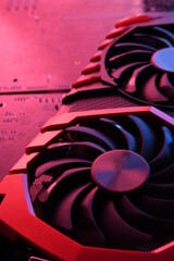Poster - Computer game graphics card, videocard with two coolers on circuit board ,motherboard background. Close-up. With red-blue lighting
