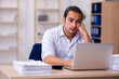 © Elnur - Young businessman employee unhappy with excessive work in the office