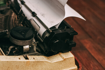 Fototapete - vintage typewriter with keys on a wooden background and a white sheet of paper