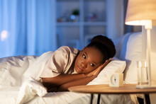 People, Bedtime And Rest Concept - Sleepless African American Woman Lying In Bed At Night