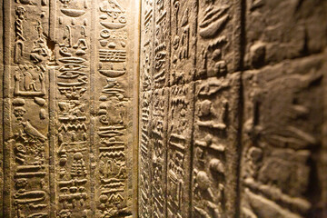 Dendera Temple complex in Egypt. Hieroglypic carvings on wall at the ancient egyptian temple.