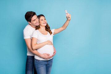 Sticker - Portrait of two persons hug belly take selfie photo wear trendy casual white isolated on blue color background