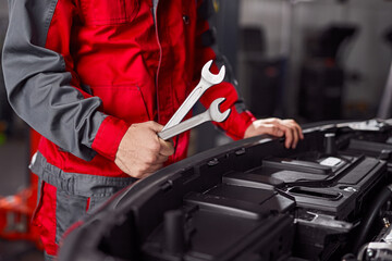 Crop mechanic with wrenches fixing car