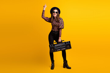 Wall Mural - Full length body size photo of funky brunette keeping cassette recorder listening song singing isolated vivid yellow color background