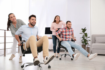 Sticker - Happy office employees riding chairs at workplace