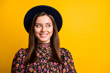 Wall Mural - Portrait of cute optimistic girl look empty space wear black cap shirt isolated on vibrant yellow color background