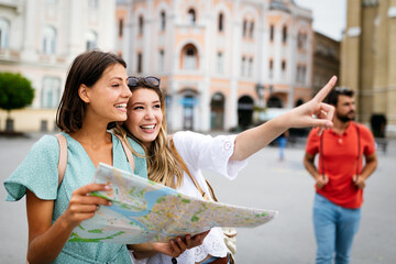 Wall Mural - happy friends enjoying sightseeing tour in the city.