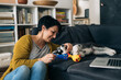© cherryandbees - Woman is playing with her little puppy at home