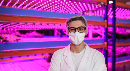 Wall Mural - Worker with face mask looking at camera on aquaponic farm, sustainable business and coronavirus.