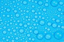 Water Drops On Blue Background Texture. Backdrop Glass Covered With Drops Of Water. Bubbles In Water