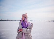 A Girl With Purple Hair Stands On A Snow-covered Lake