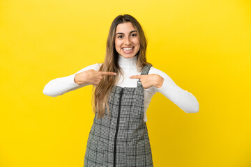 Wall Mural - Young caucasian woman isolated on yellow background with surprise facial expression