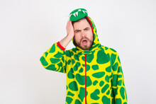 Embarrassed Young Caucasian Man Wearing A Pajama Standing Against White Background With Shocked Expression, Expresses Great Amazement, Puzzled Model Poses Indoor