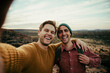 © Prins Productions - Caucasian male friends hiking in wilderness taking selfie with cellular device embracing the outdoors