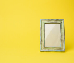 empty rectangular blank wooden frame, yellow background