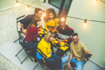 Wall Mural - Happy friends having barbecue party dinner in the rooftop  - Multiracial people having fun drinking cocktails sitting in villa backyard -  Focus on lights