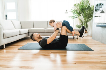 Wall Mural - Nice father training with his baby at home